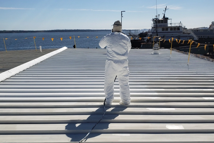 guy doing something on a roof in a hazmat suit