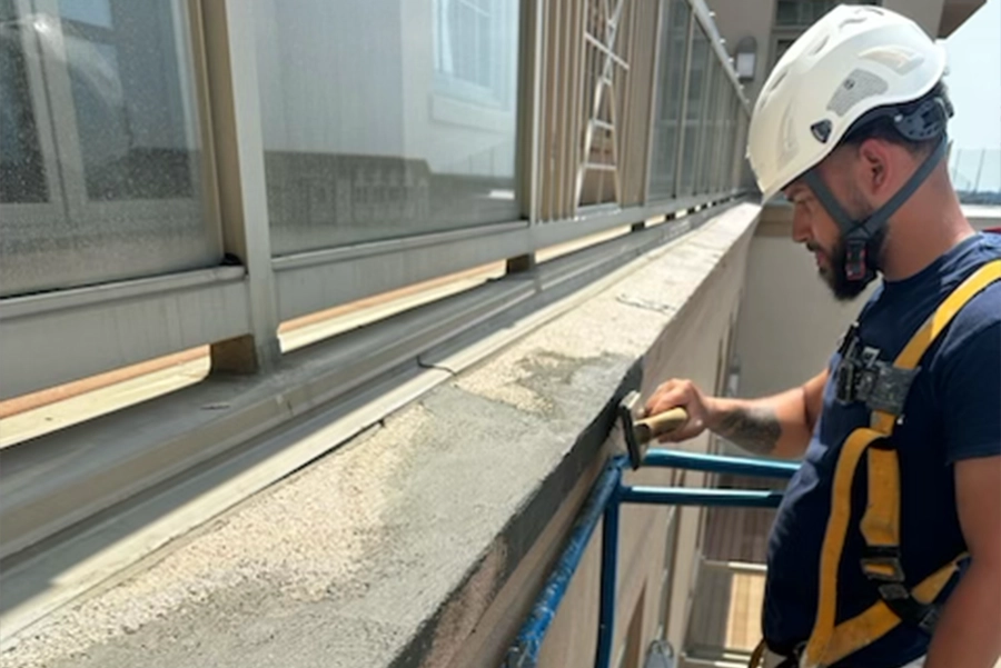 man restoring the end of a cement wall